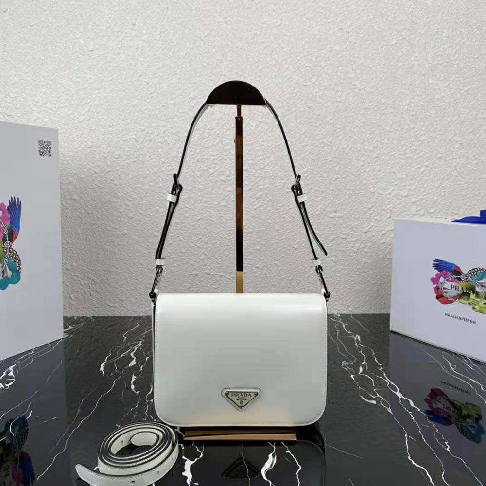 Close-up of silver hardware and Prada logo on white brushed leather bag