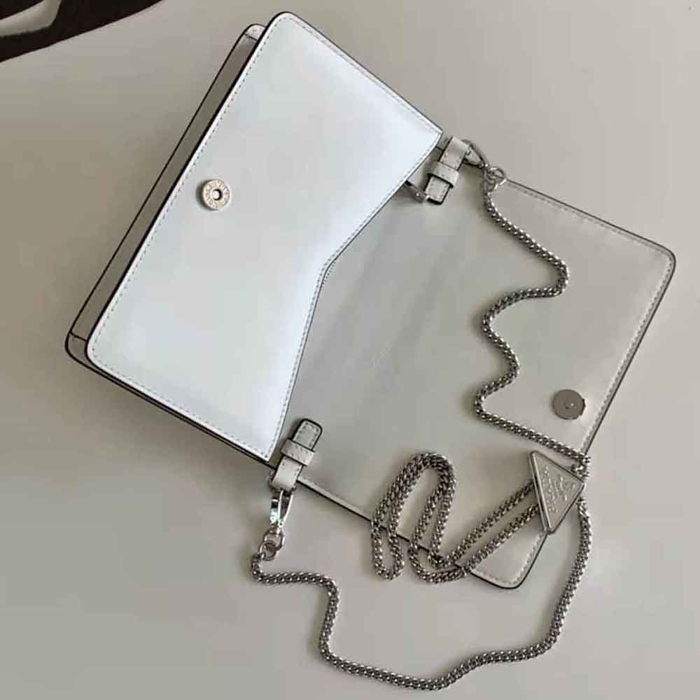 Side angle displaying adjustable strap and compact silhouette of Prada shoulder bag