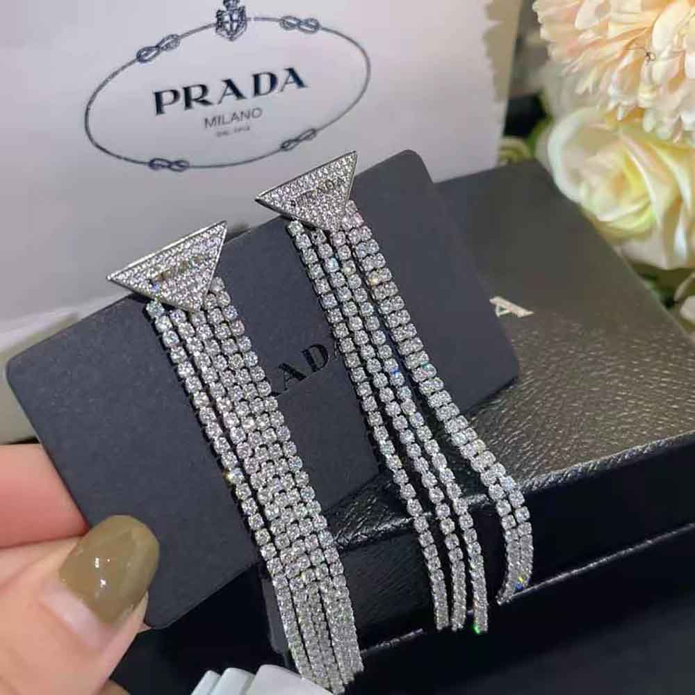 Side angle highlighting silver finish and secure butterfly closure on Prada Earrings