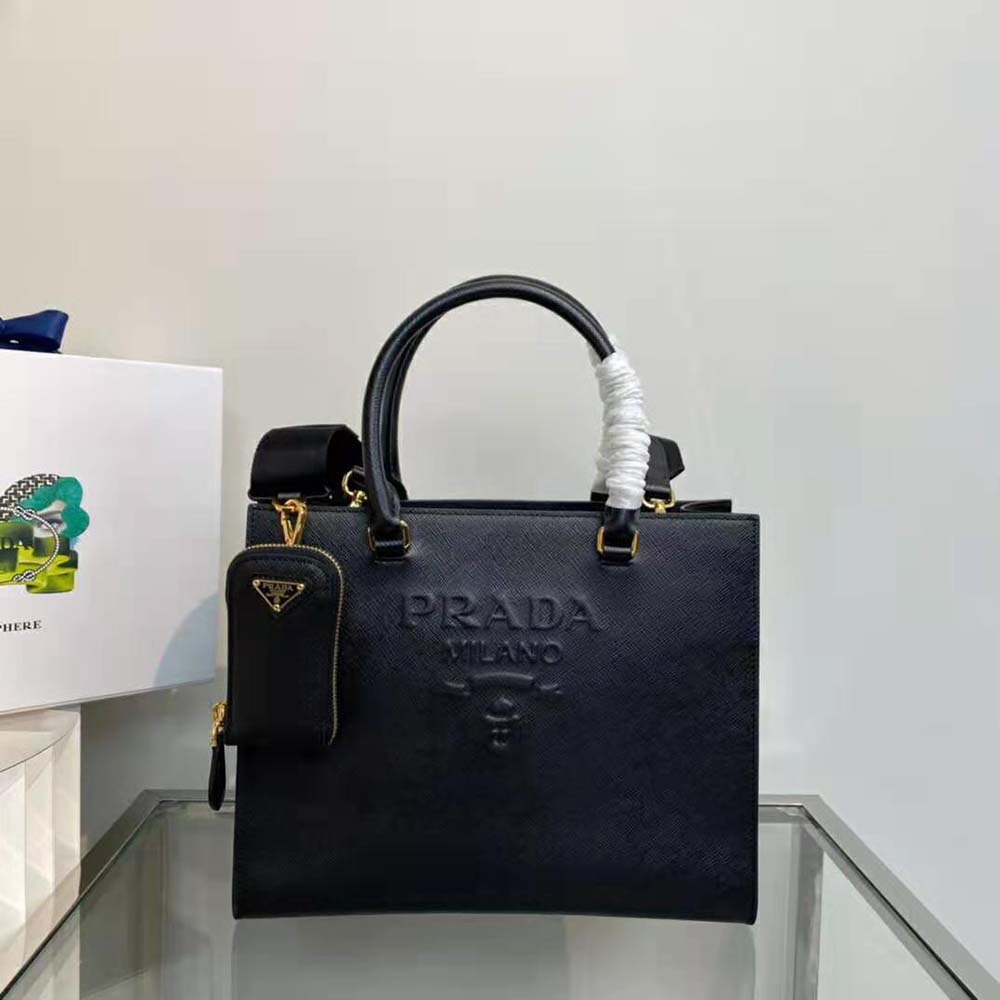 Close-up on gold-tone hardware and textured leather of Prada handbag