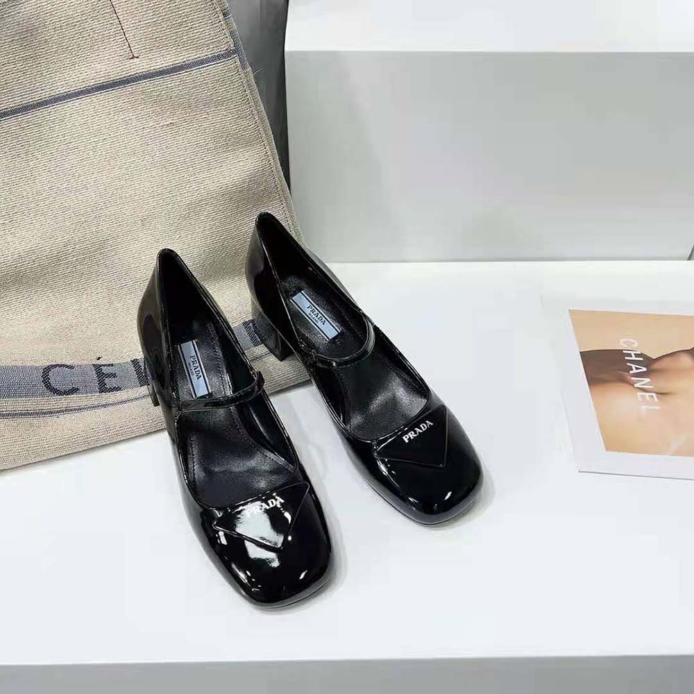 Close-up of glossy patent leather and heel detail on Prada pumps
