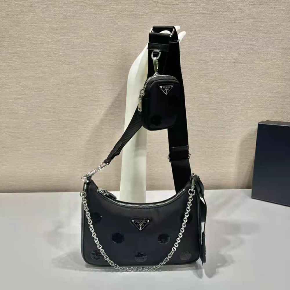 Close-up of silver Prada logo hardware on polka-dot bag