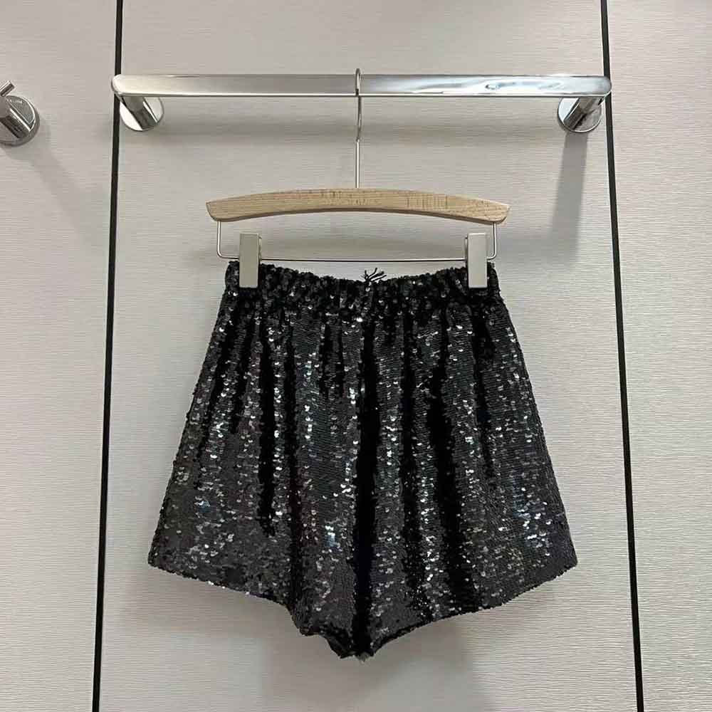 Side angle highlighting elastic waistband of Prada sparkling shorts