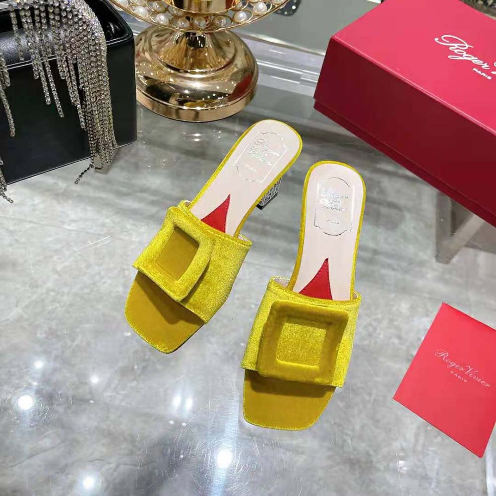 Top-down angle showing yellow velvet upper and signature buckle detail