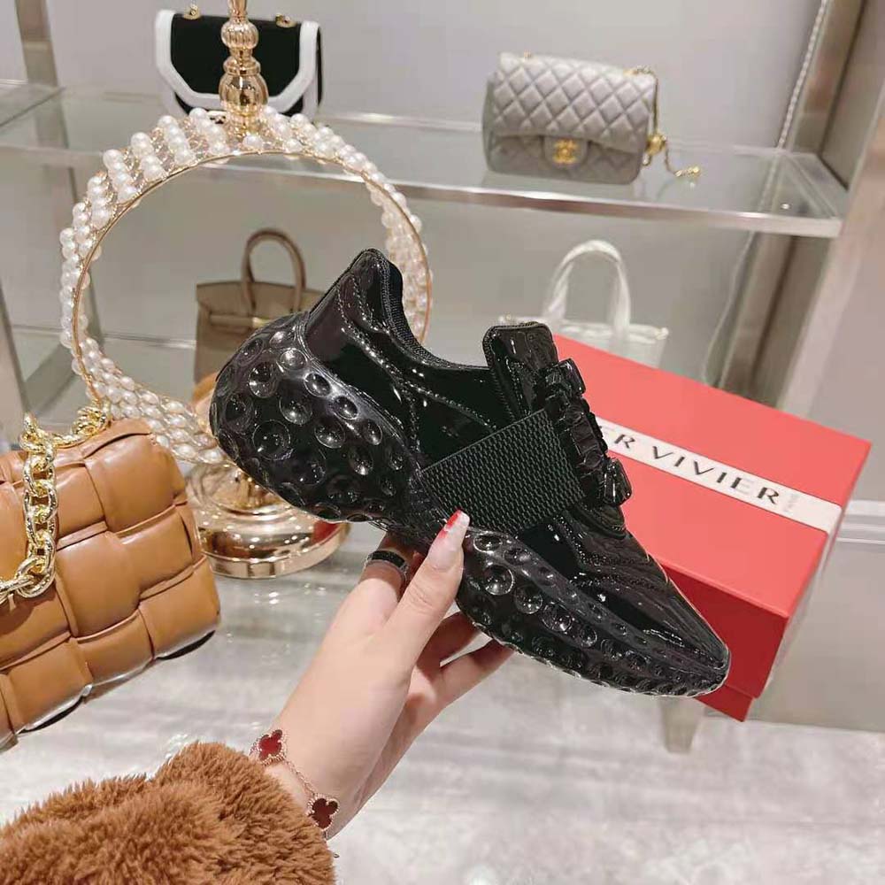 Close-up of sparkling strass buckle detail on Roger Vivier Black sneakers