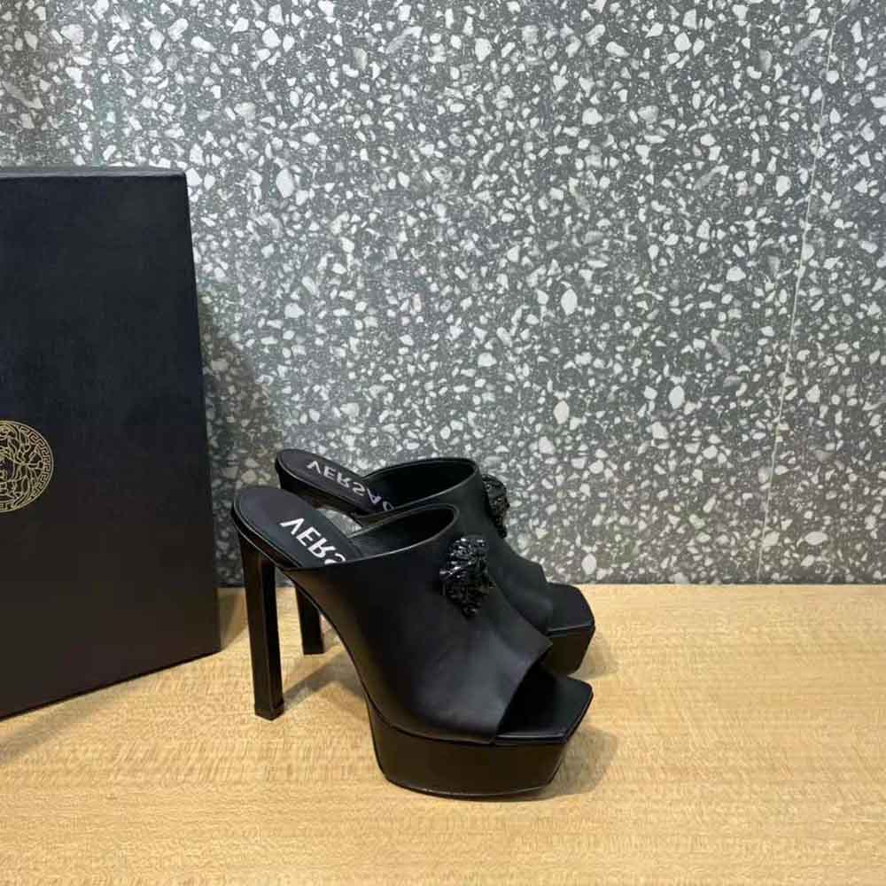 Top view showing black calf leather texture on Versace La Medusa mules