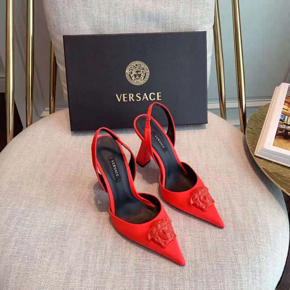 Close-up of gold Medusa hardware on Versace Women La Medusa Satin Sling-Back Pumps