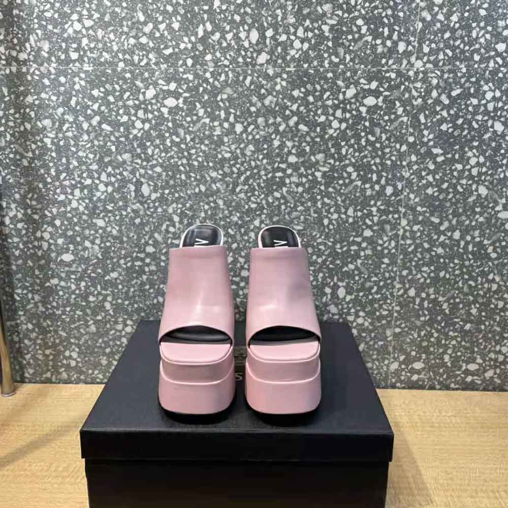 Close-up of gold Medusa emblem on pink Versace Women Platform Mules