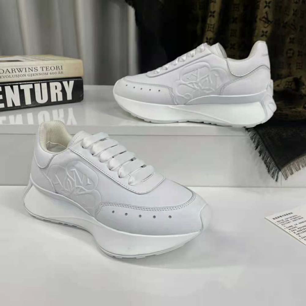 Close-up on laces and embossed logo of Alexander Mcqueen Sprint Runner white sneaker