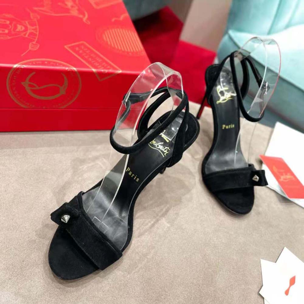 Close-up of black suede and signature red sole on Umberta 100 mm sandal