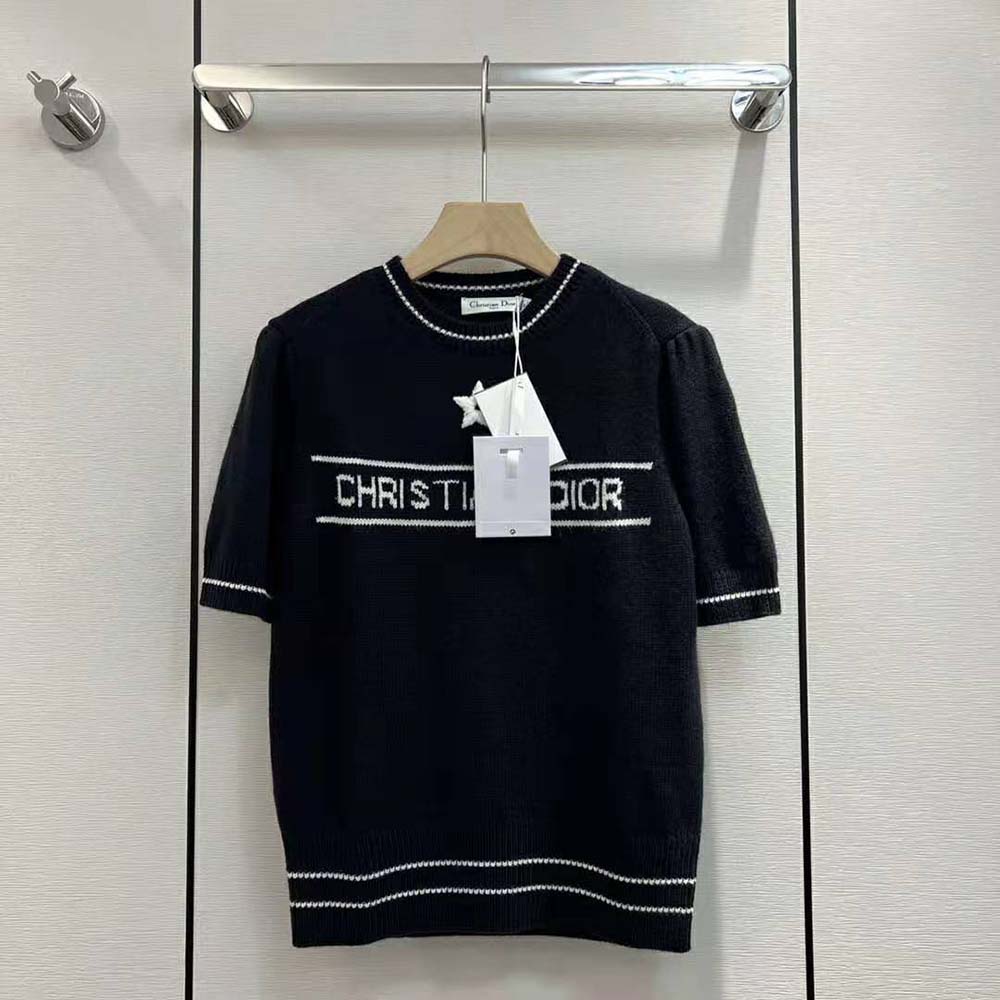 Close-up detail of navy knit texture and Dior logo embroidery