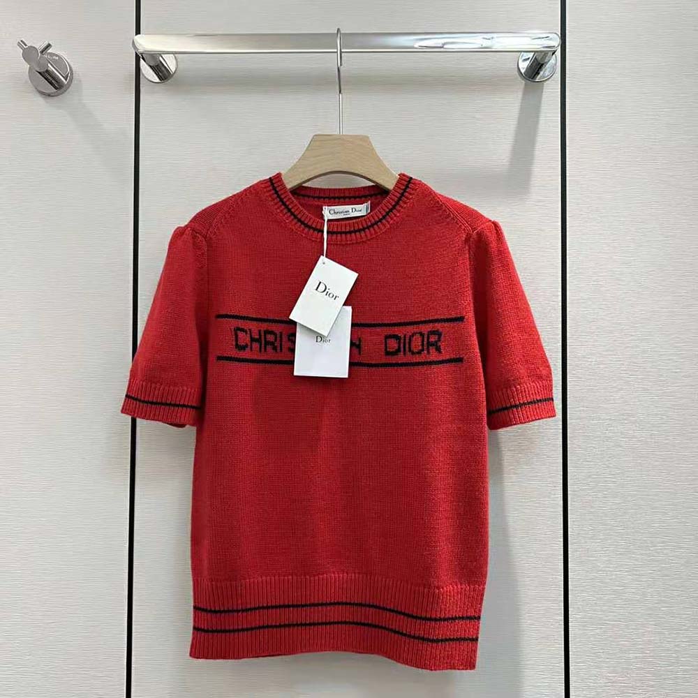 Close-up of red knit texture and Dior logo embroidery on short-sleeved sweater