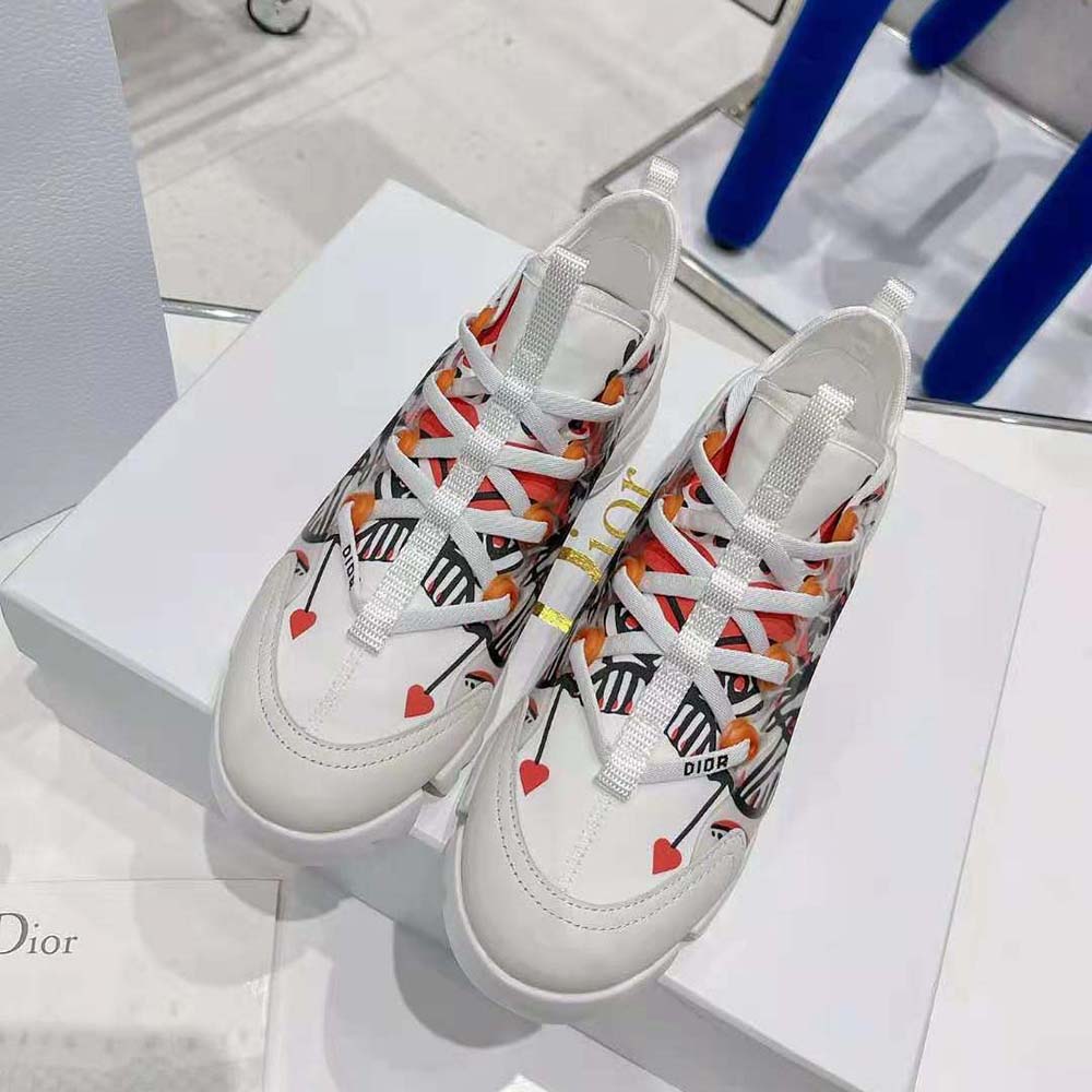 Close-up of red and black Cupidon print on Dior sneaker upper
