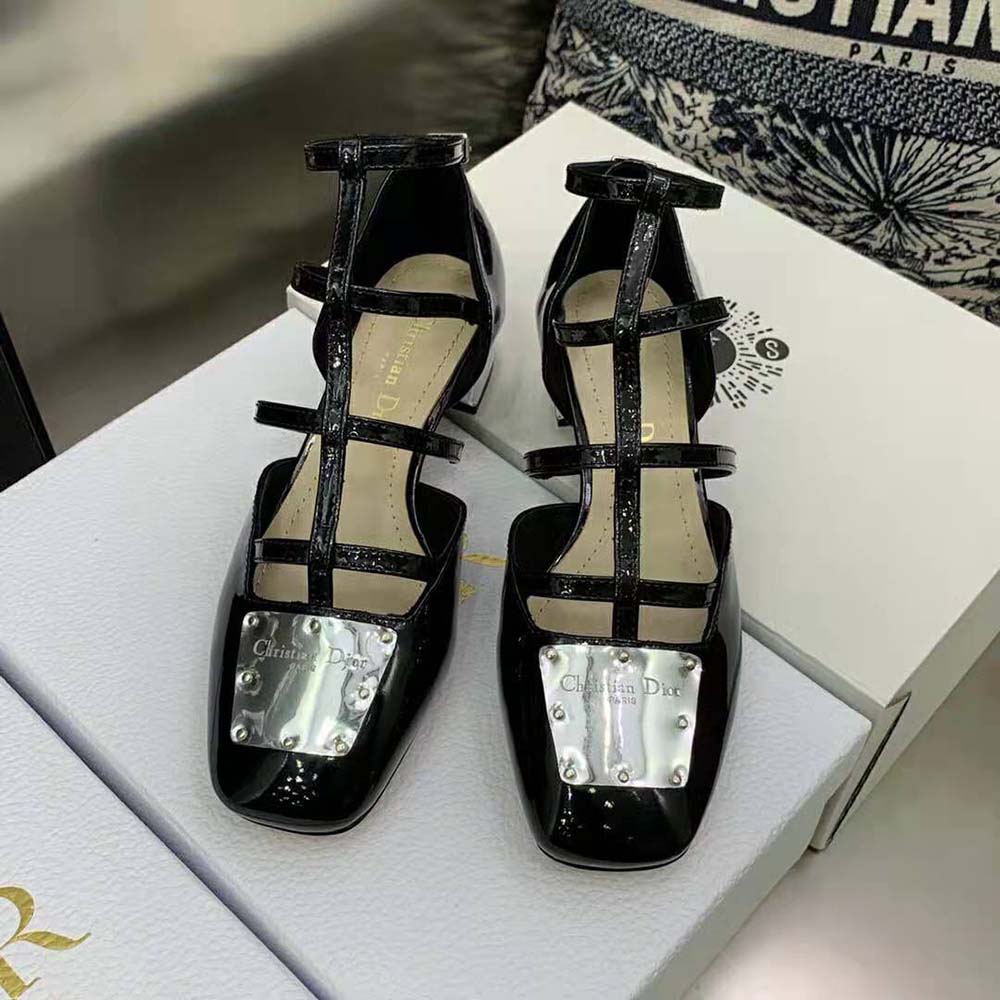 Close-up on signature Dior bow and metal accent on ballerina flat
