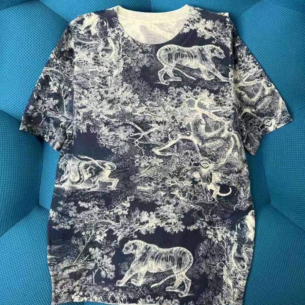 Close-up detail of Dior Toile de Jouy pattern on navy blue T-shirt