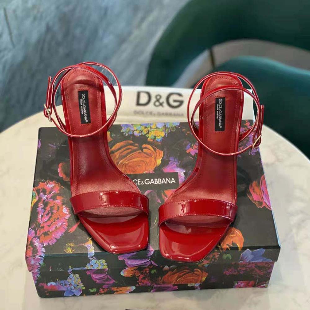 Close-up of glossy red patent leather and D&G logo buckle detail