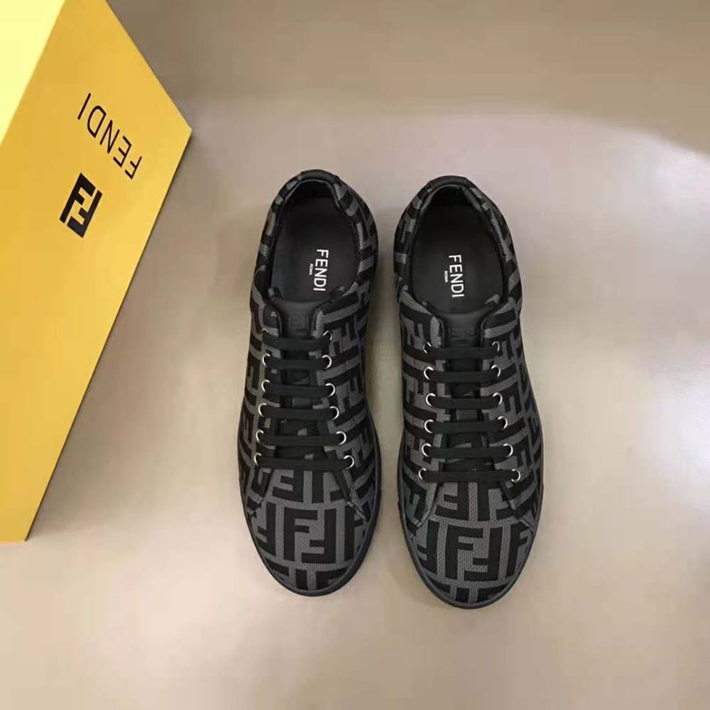 Close-up of brown tech fabric and Fendi logo hardware on sneakers