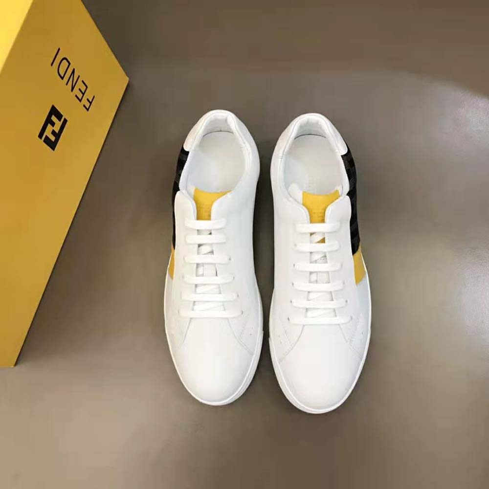 Close-up detail of embossed Fendi logo on white leather sneaker tongue