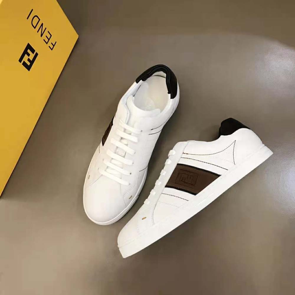Top-down angle showcasing white leather and Fendi logo on sneakers
