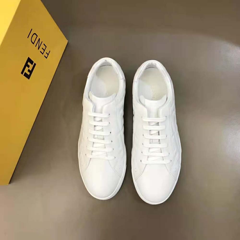 Close-up of 3D embossed Macro FF motif on white leather sneaker