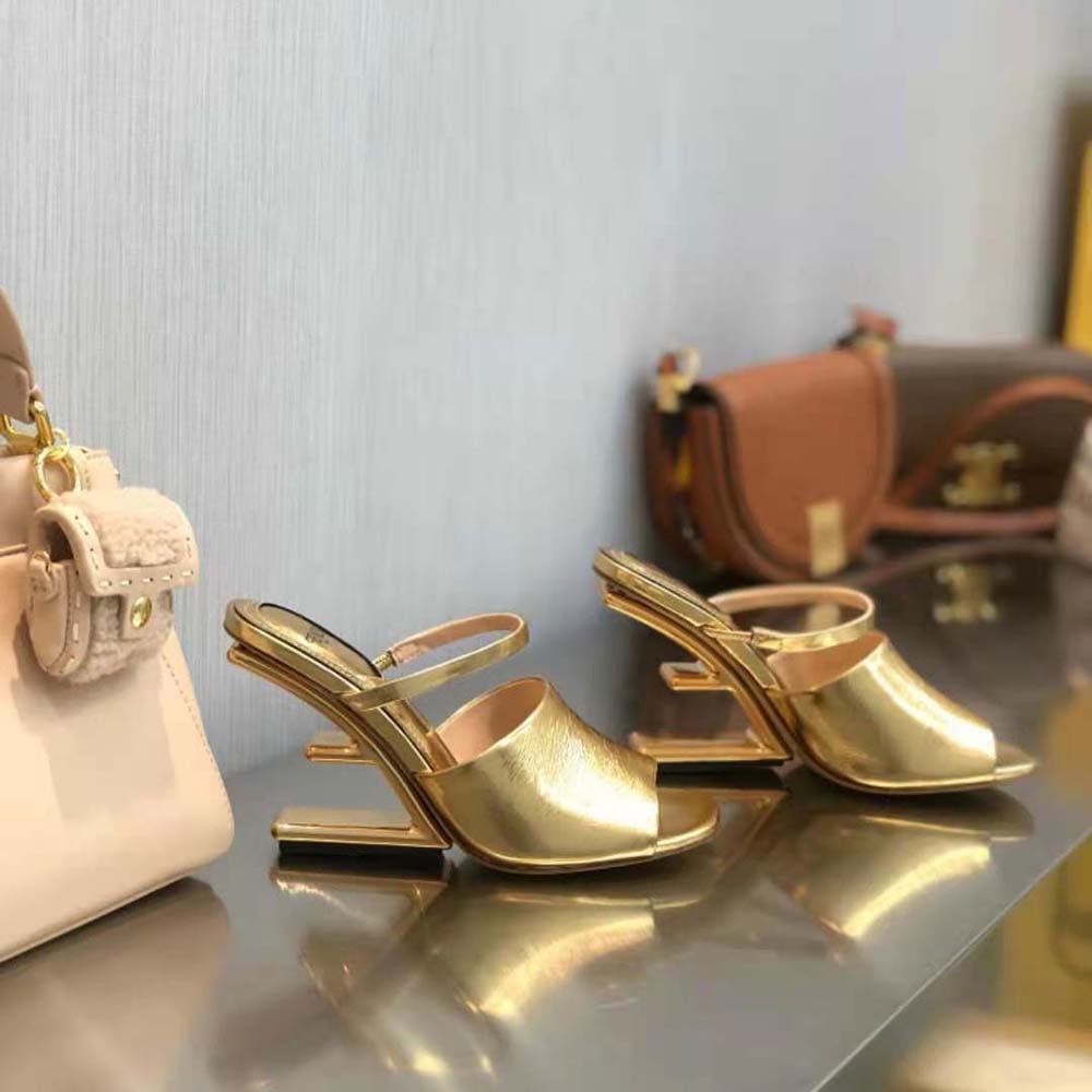 Close-up detail of gold buckle on Fendi Women First sandals