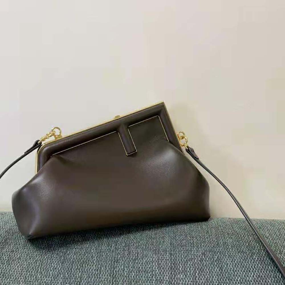 Close-up detail of leather texture and signature clasp on Fendi Women First Small Dark Brown Leather Bag