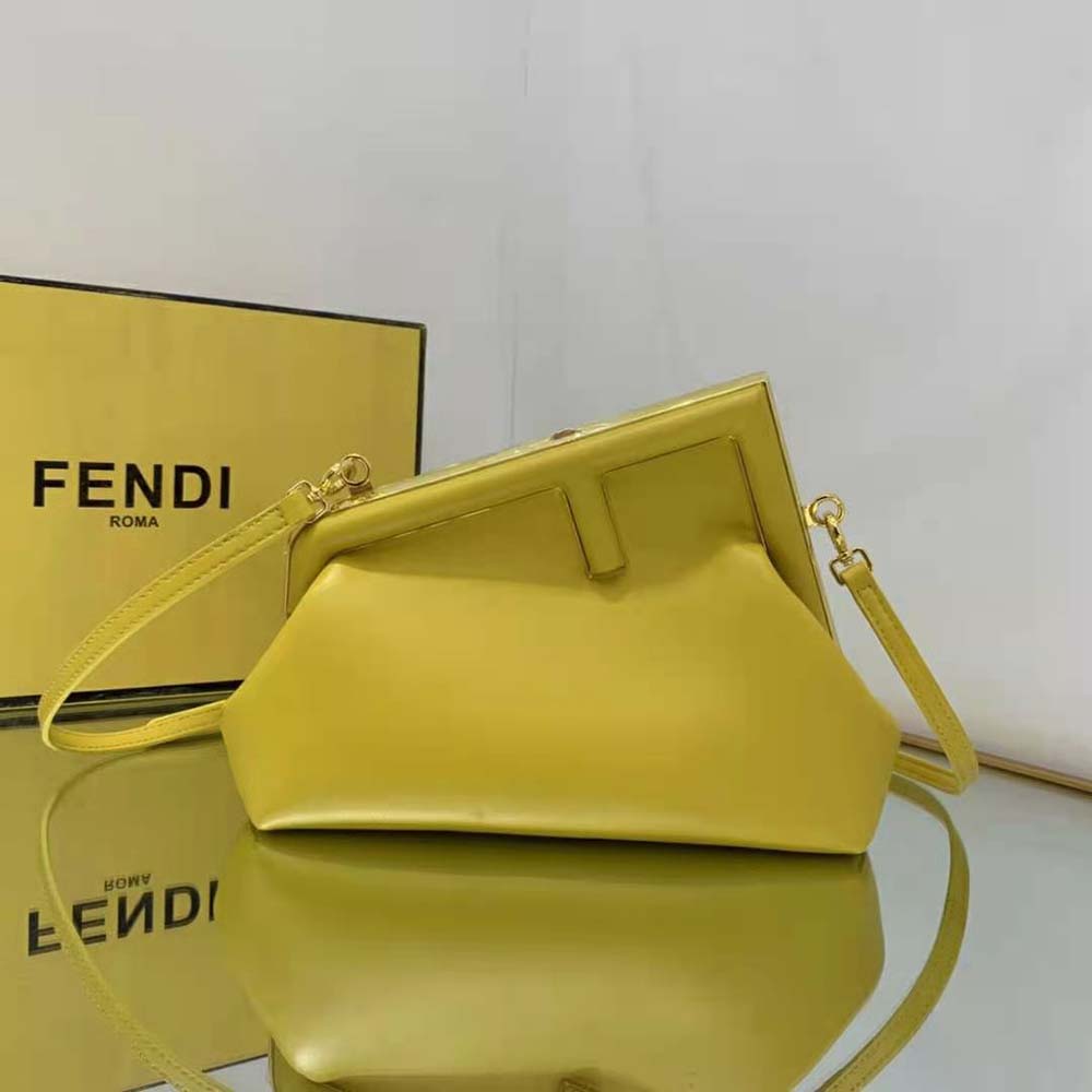 Close-up of signature gold push-lock on Fendi Women First Small Yellow Leather Bag