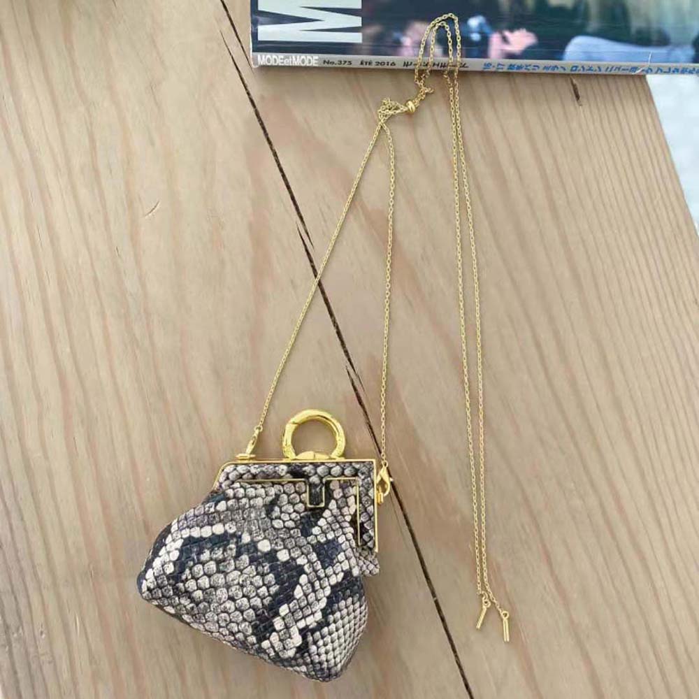 Close-up of gold-tone hardware and charm on Fendi Women Nano Fendi First Charm