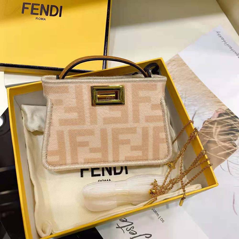 Close-up of gold-tone hardware and pink charm on Fendi Women Nano Peekaboo