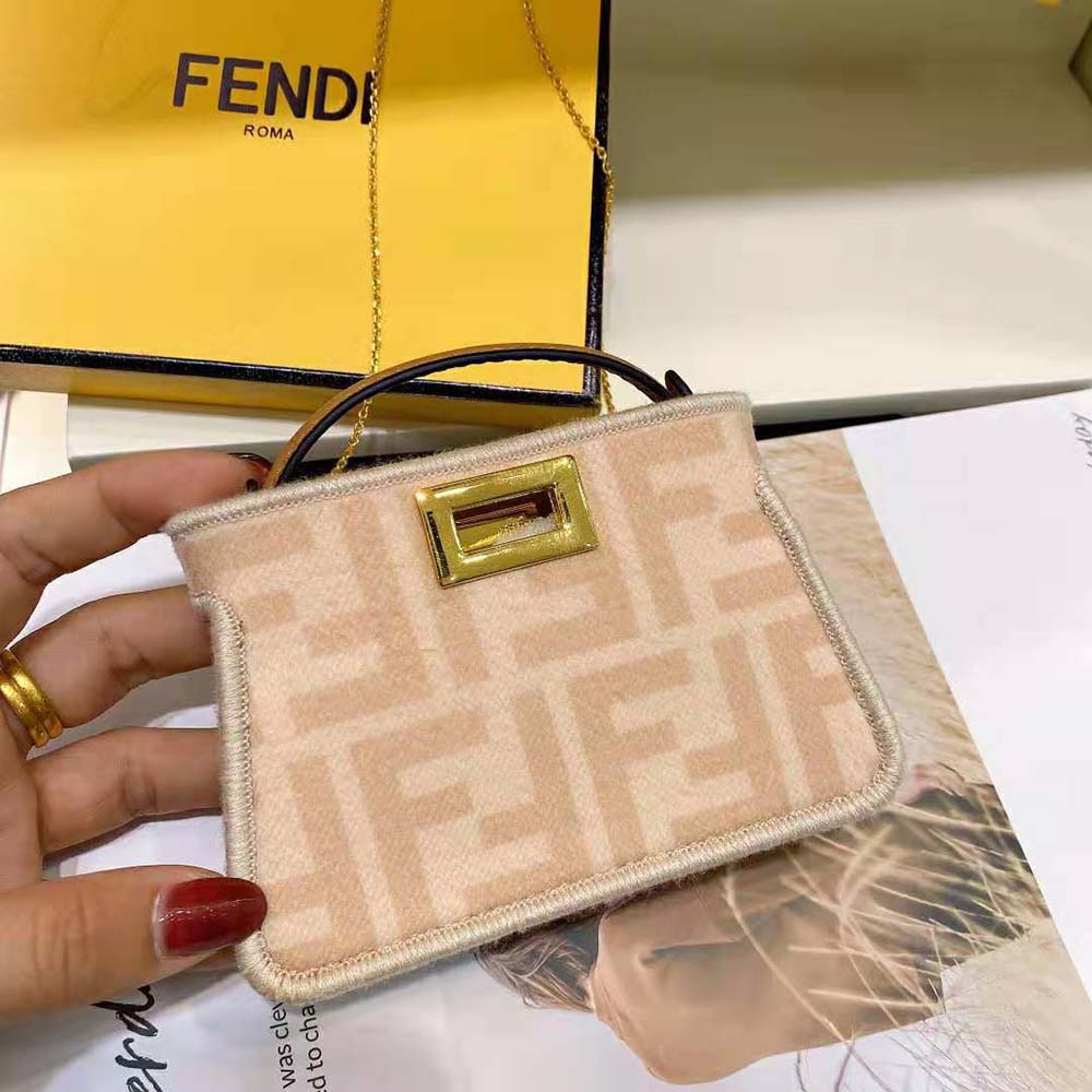 Side angle showing compact silhouette of Fendi Women Nano Peekaboo Charm Pink