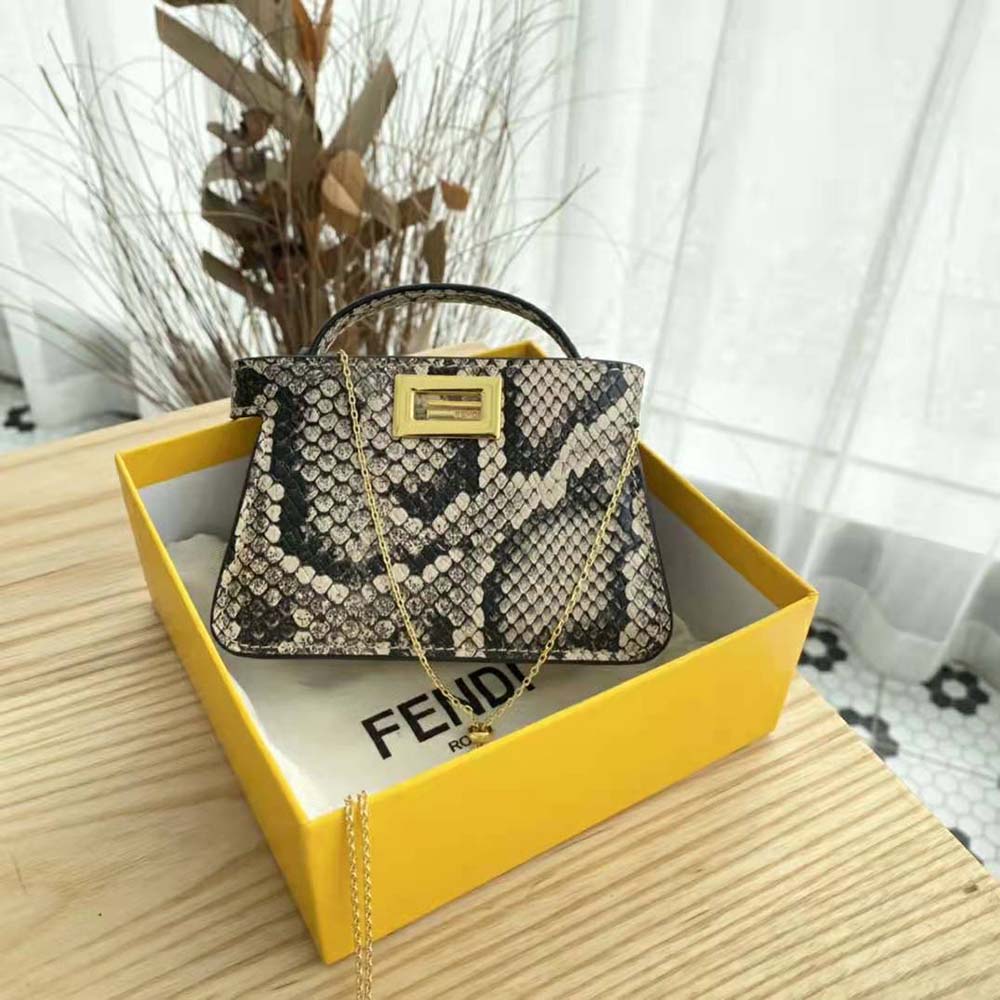 Close-up on gold-tone hardware and python texture of the Fendi Nano bag