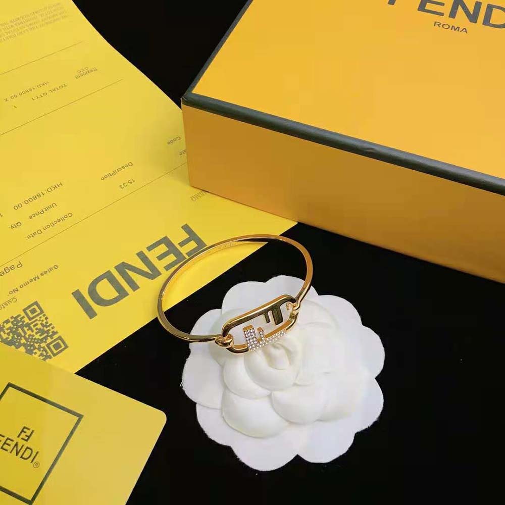 Side angle showing Fendi Women O Lock Bracelet’s sleek gold silhouette