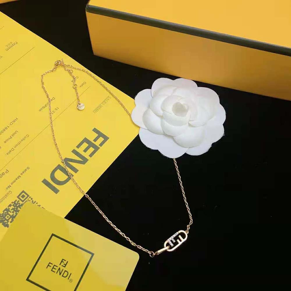 Close-up of Fendi O Lock pendant detail on gold-colored necklace