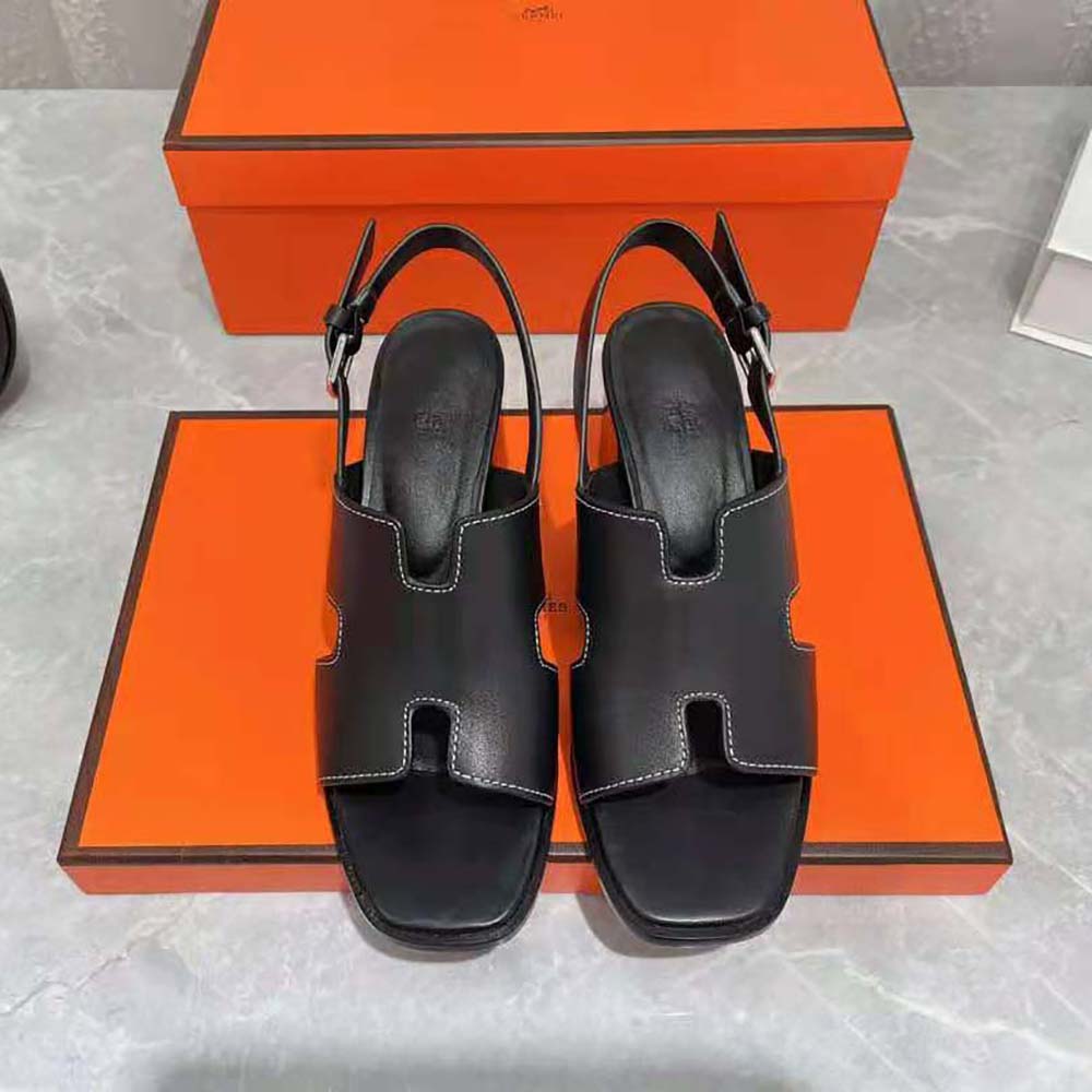 Close-up of signature Hermes hardware on Elbe 60 black sandal