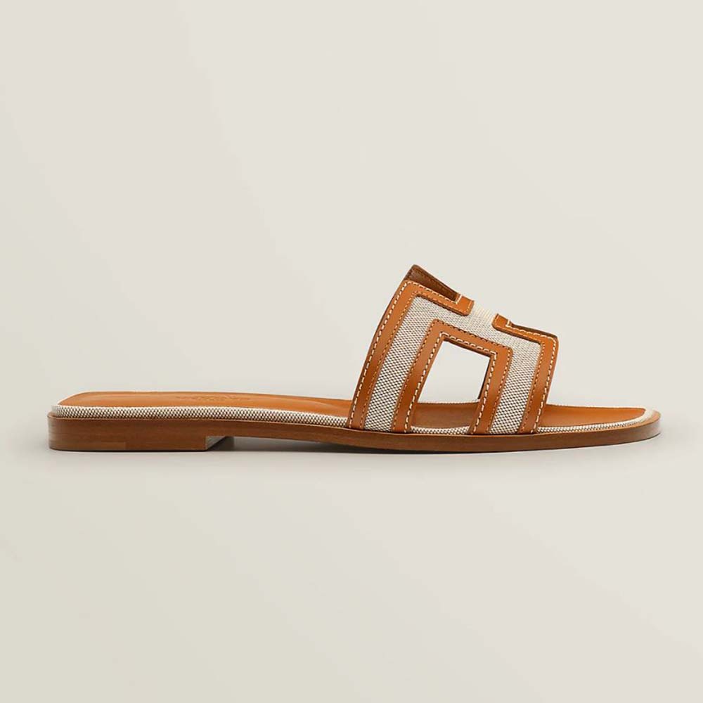 Side view of Hermes Women Oran Sandal in brown calfskin and H canvas