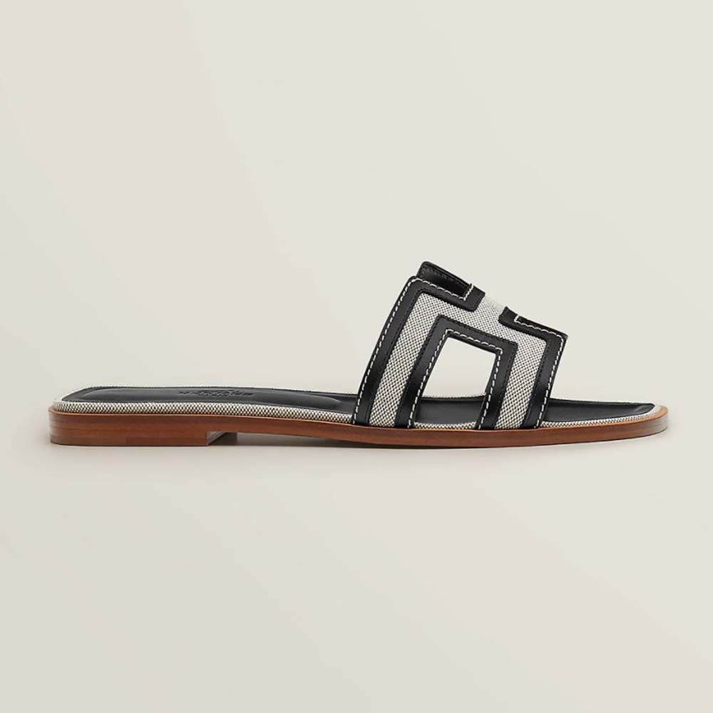 Side profile of Hermes Women Oran Sandal in black calfskin and canvas