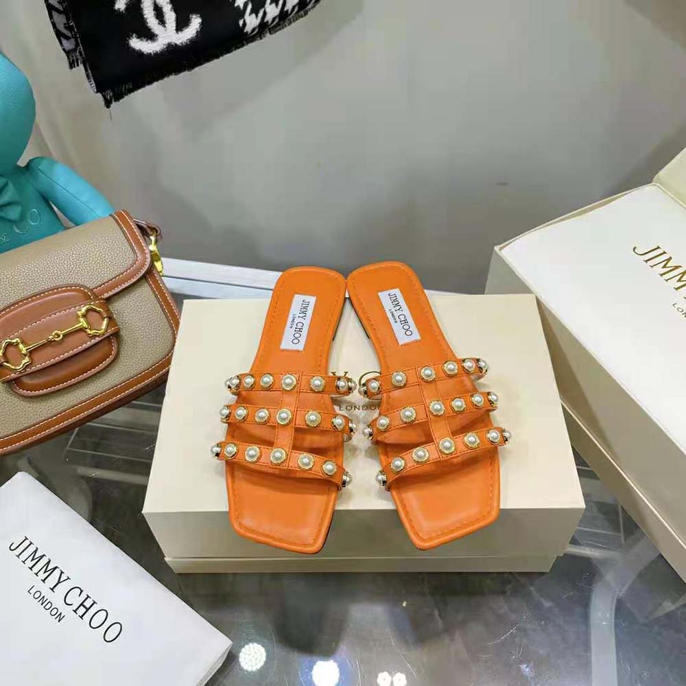 Close-up on pearl studs of Jimmy Choo Women Hazal Amber Orange flats