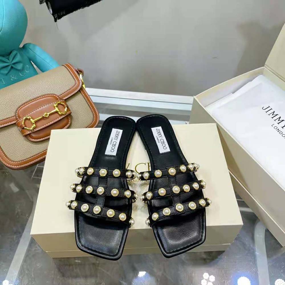 Close-up of pearl stud detailing on Jimmy Choo Women Hazal Flats in black nappa