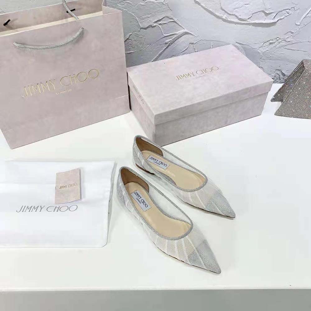 Close-up of glitter fabric and silver shimmer on Jimmy Choo flats