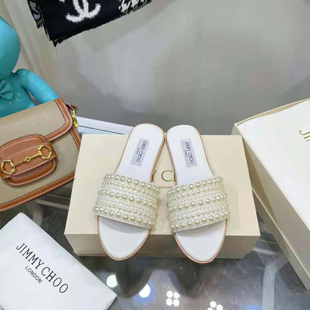 Close-up on pearl embellishments of Jimmy Choo Women Minea Flat White Satin Flats
