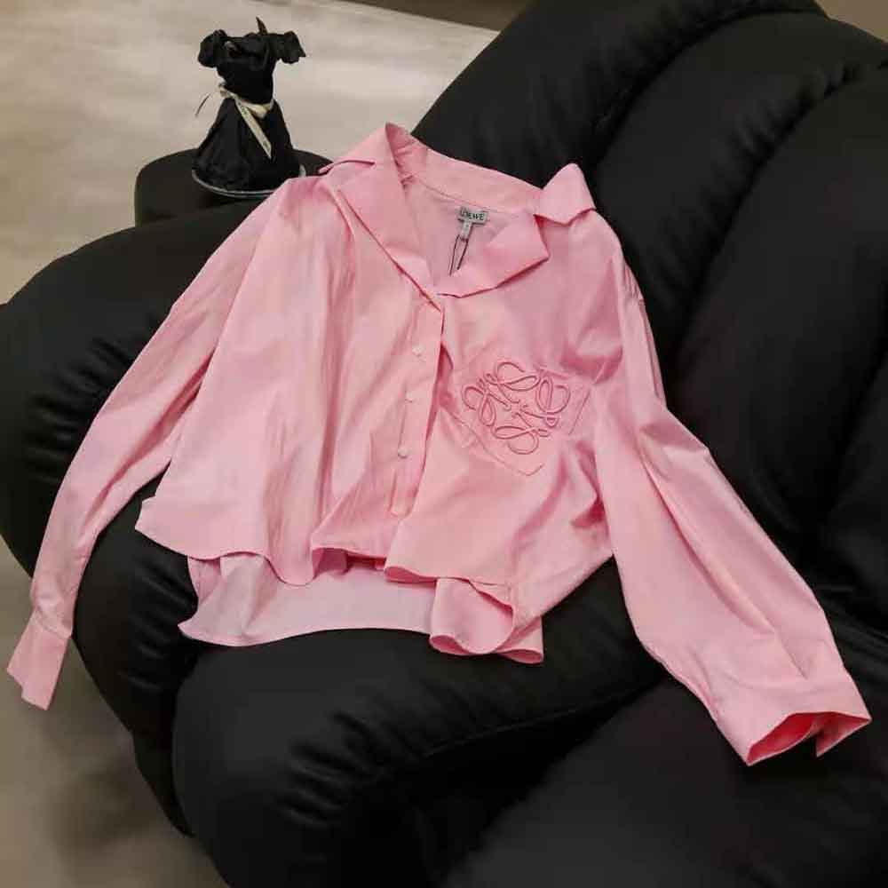 Close-up of embroidered Anagram detail on pink Loewe blouse
