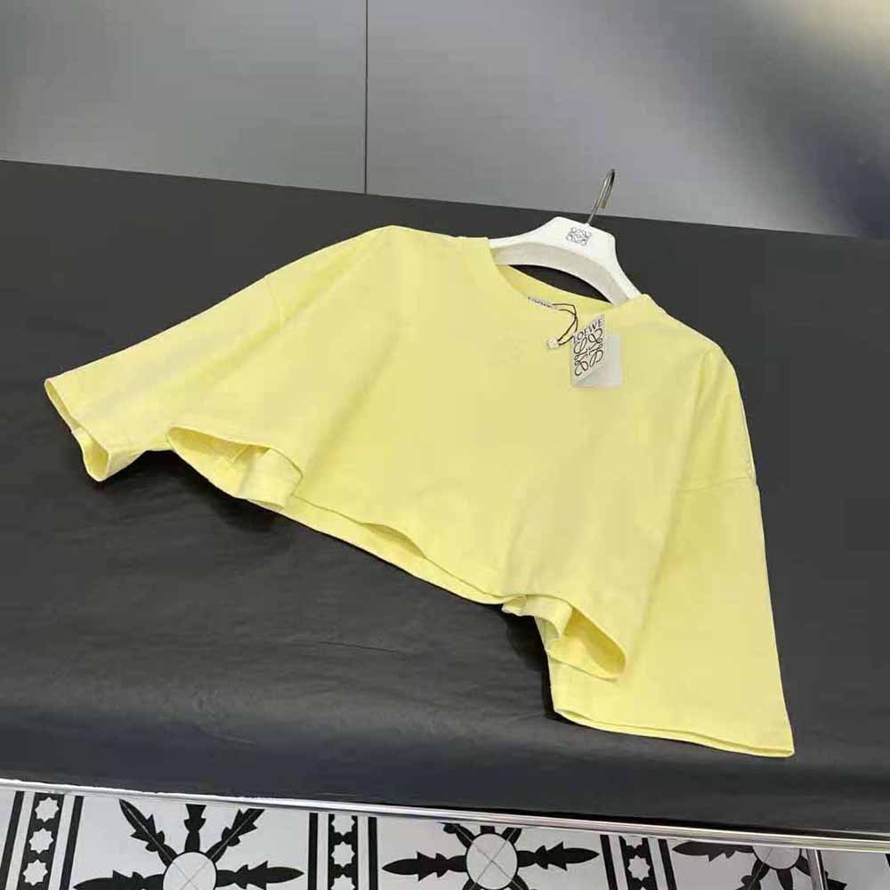 Close-up of embroidered Loewe Anagram detail on cotton-yellow t-shirt