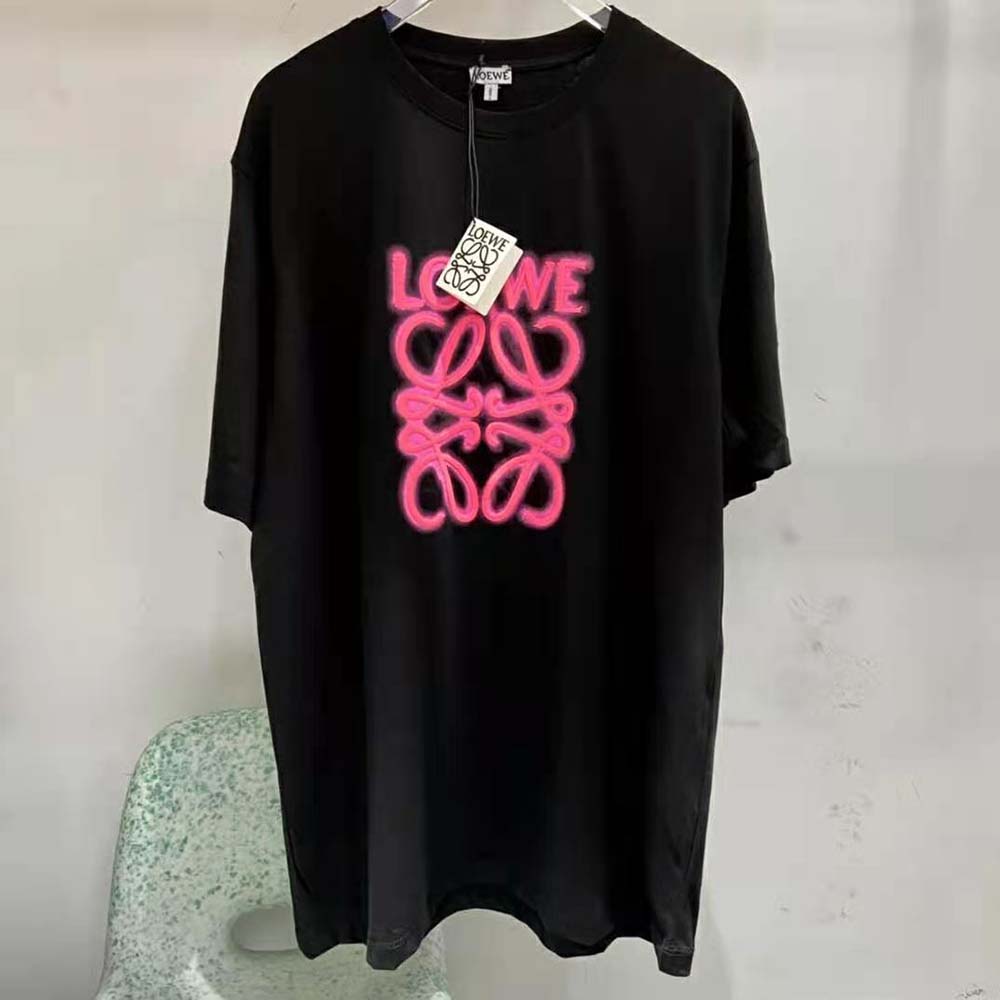 Close-up of neon pink LOEWE logo on black cotton T-shirt