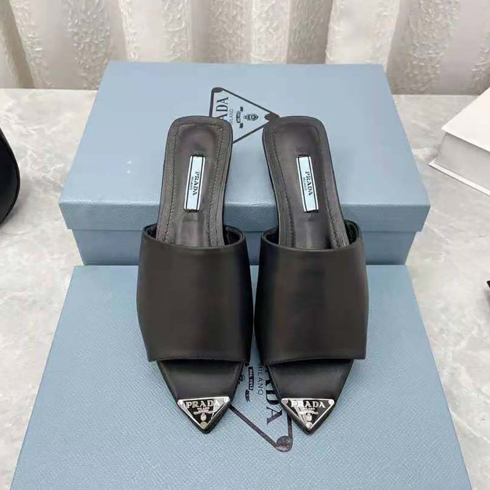 Close-up detail of brushed leather and modernist line on Prada slides