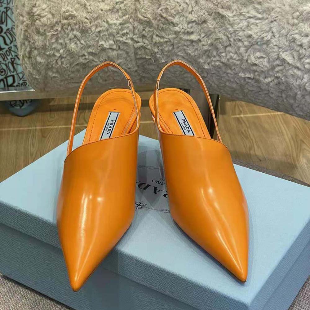 Top view showing adjustable slingback strap on Prada orange pumps