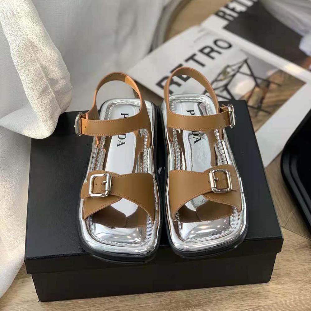 Close-up of brown leather texture and embossed Prada logo detail on sandals