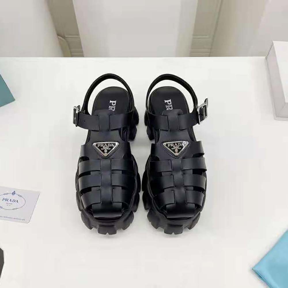 Close-up detail of buckle and Prada logo on black foam rubber sandal