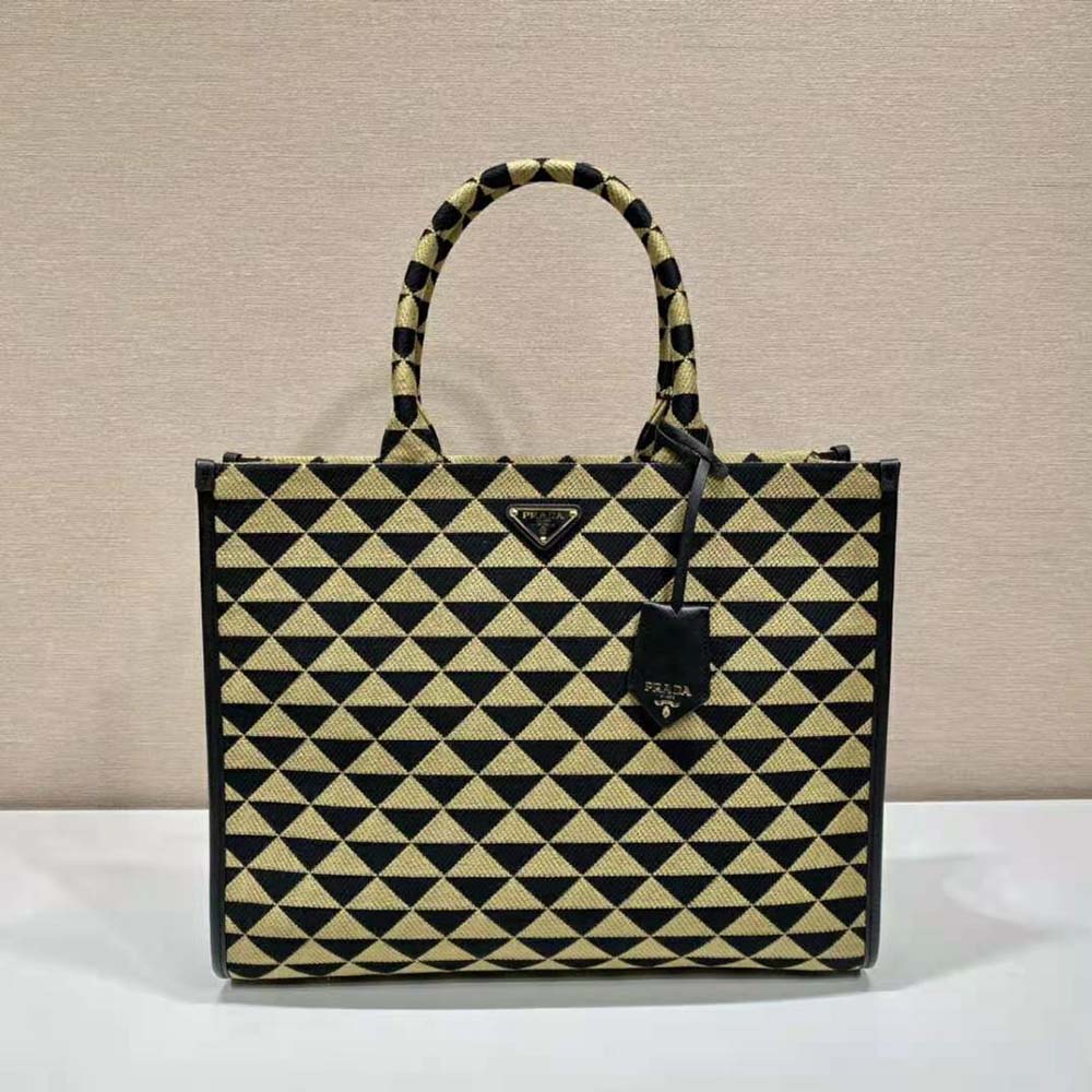 Close-up detail of jacquard fabric and gold hardware on Prada handbag