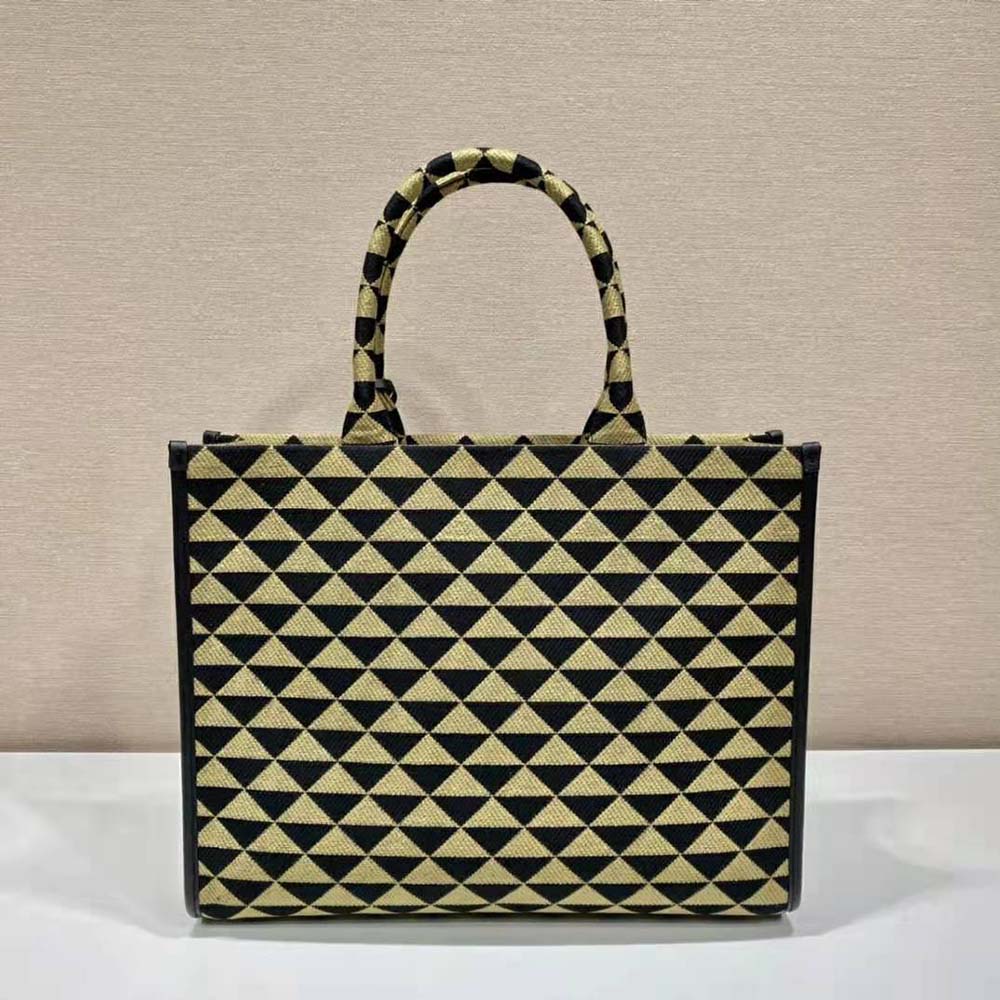 Side angle showing roomy silhouette of Prada Women Large Prada Symbole Jacquard Fabric Handbag-Brown
