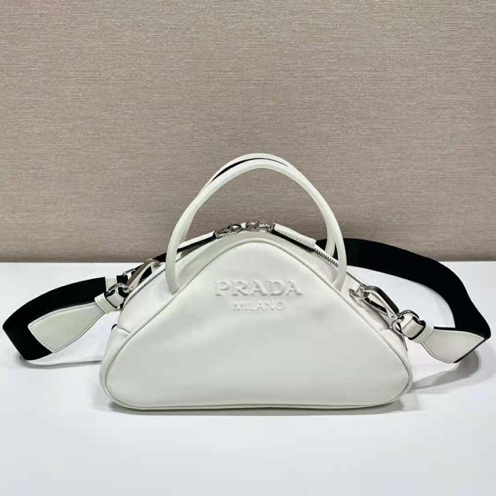 Close-up of white leather texture and Prada triangle logo plaque